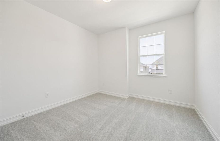 Roomy secondary bedroom with extensive closet storage  *Real home pictured