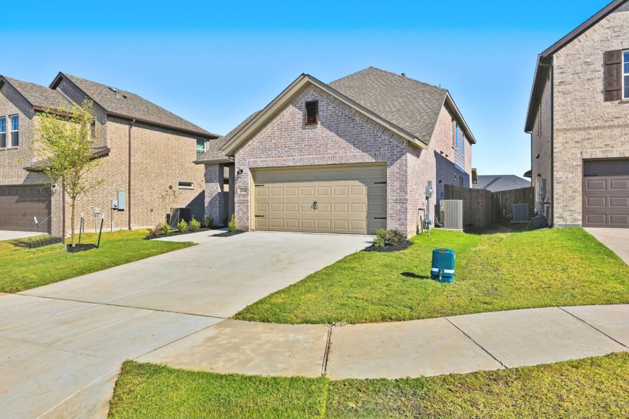 Front exterior of a new home in Elevon, Lavon, TX, highlighting curb appeal (Image 25).