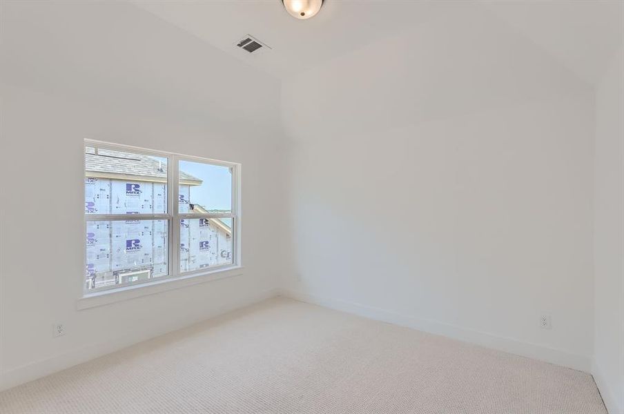 Spare room featuring light colored carpet