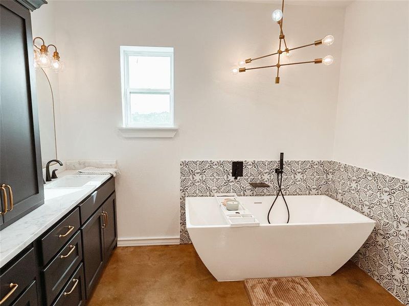 Bathroom with vanity, a freestanding bath, and a chandelier Bathroom with vanity, a freestanding bath, and a chandelier