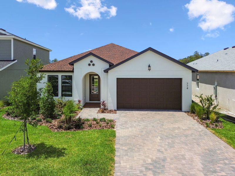 Front exterior of a new home in Avalon West, Spring Hill, FL, highlighting curb appeal (Image 10).
