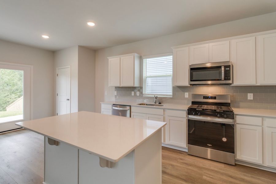 Longspur Kitchen with bright white cabinets.