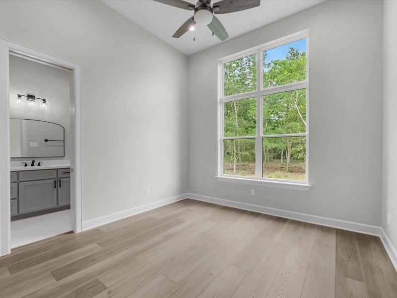 Light-filled secondary bedroom with neutral tones and modern finishes.