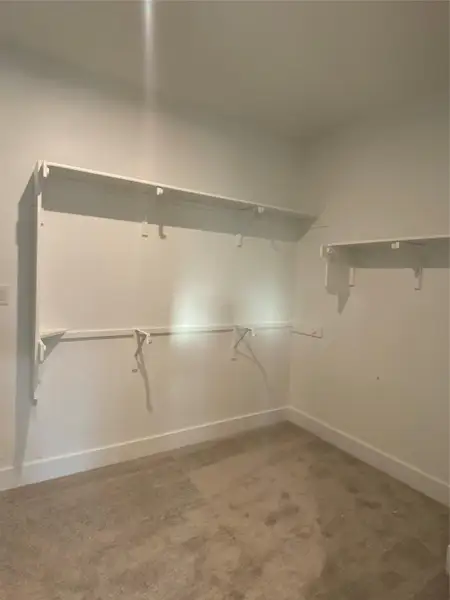 Walk-in closet in Primary Bedroom Walk-in closet in Primary Bedroom