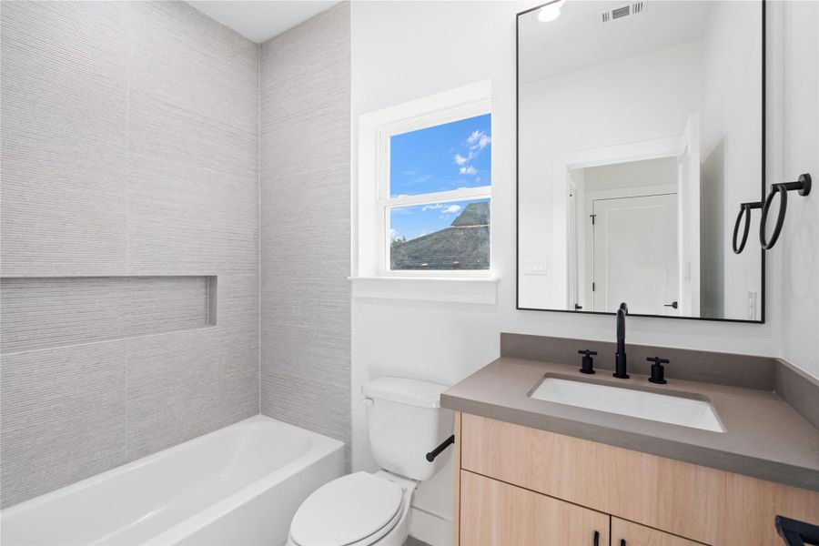 The secondary bedrooms each feature a private ensuite that mirrors the home’s sophisticated Scandinavian-inspired design. These cohesive, stylish bathrooms offer both comfort and functionality, creating a personal retreat for family or guests.