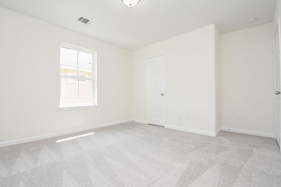 Empty room with grey carpet, white walls, a window with blinds, and a closed white door. Empty room with grey carpet, white walls, a window with blinds, and a closed white door.