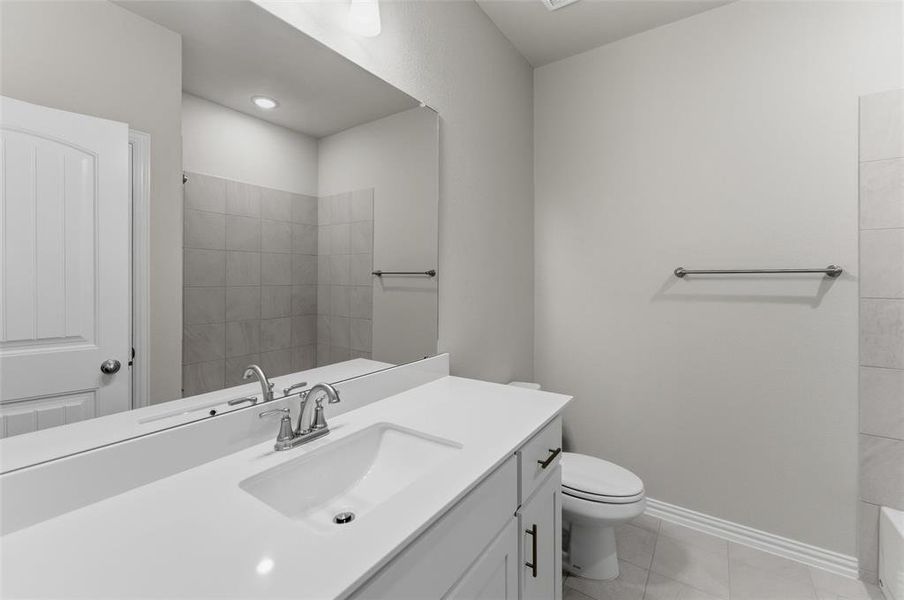 Single vanity with a rectangular undermount sink, a chrome faucet, and a light-colored countertop
