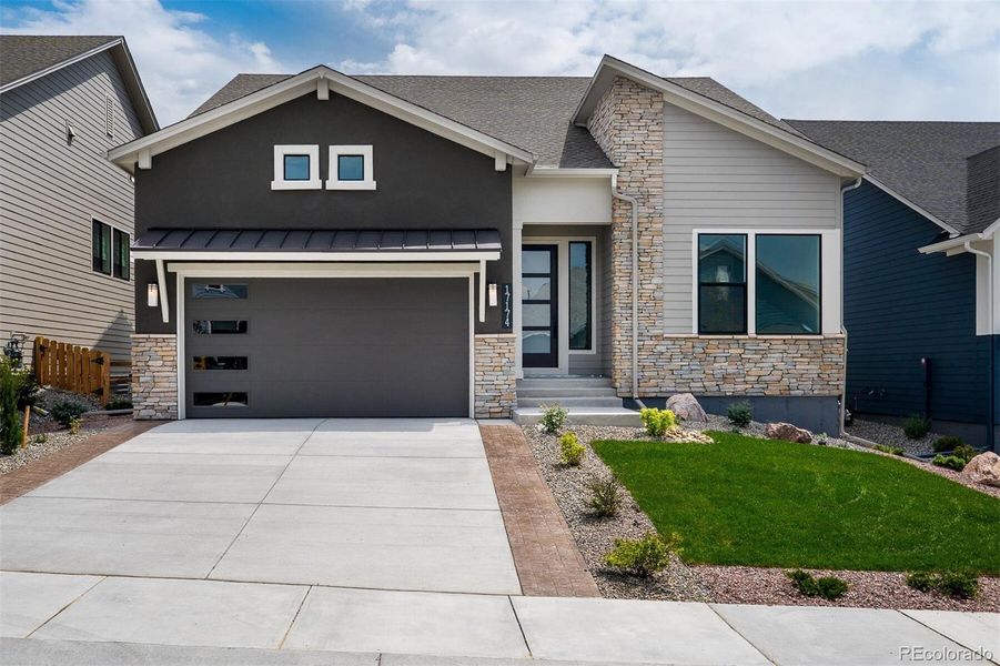 Front exterior of a new home in Cloverleaf – Mountainview Collection, Monument, CO, highlighting curb appeal (Image 1).