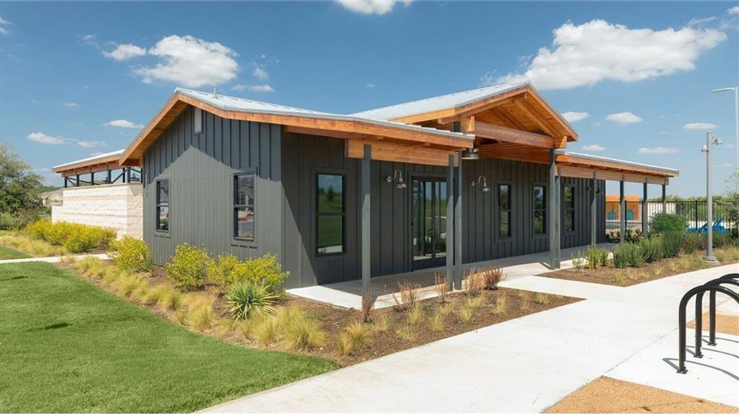 A modern building showcases a sleek facade with a welcoming covered entrance and exposed wood beam accents. A modern building showcases a sleek facade with a welcoming covered entrance and exposed wood beam accents.