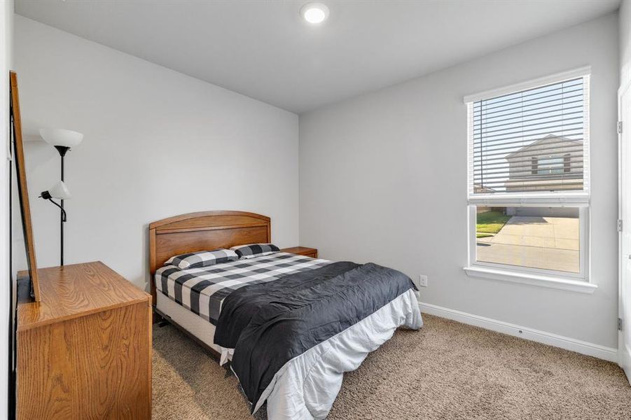 Carpeted bedroom with baseboards