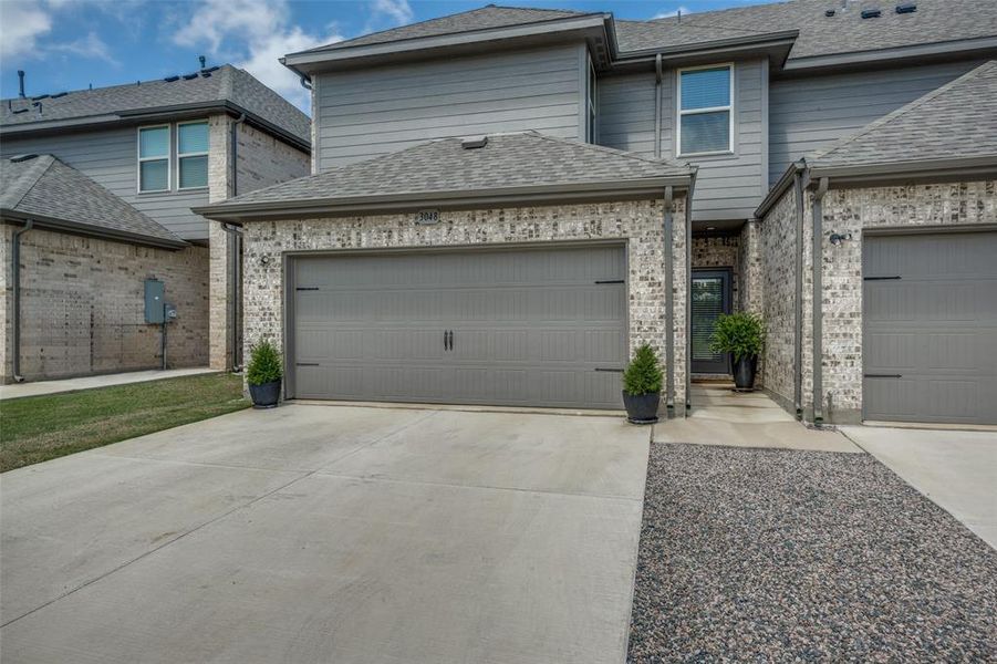 Rear-entry two-car garage with private driveway and direct access to the home.