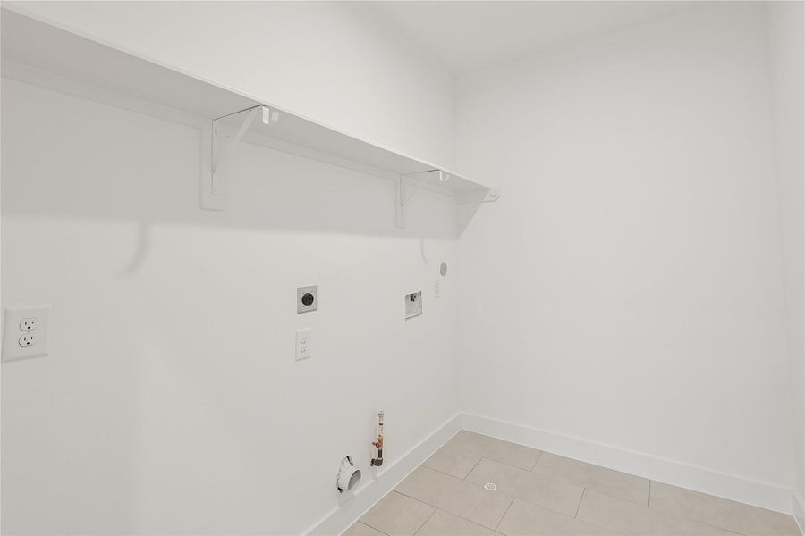 Well-appointed utility room with a generous layout, offering plenty of room for laundry, storage, and organization. Designed with function in mind, it adds convenience to your daily routine.
