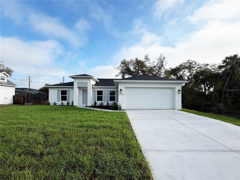 Front exterior of a new home in , North Port, FL, highlighting curb appeal (Image 1). Front exterior of a new home in , North Port, FL, highlighting curb appeal (Image 1).