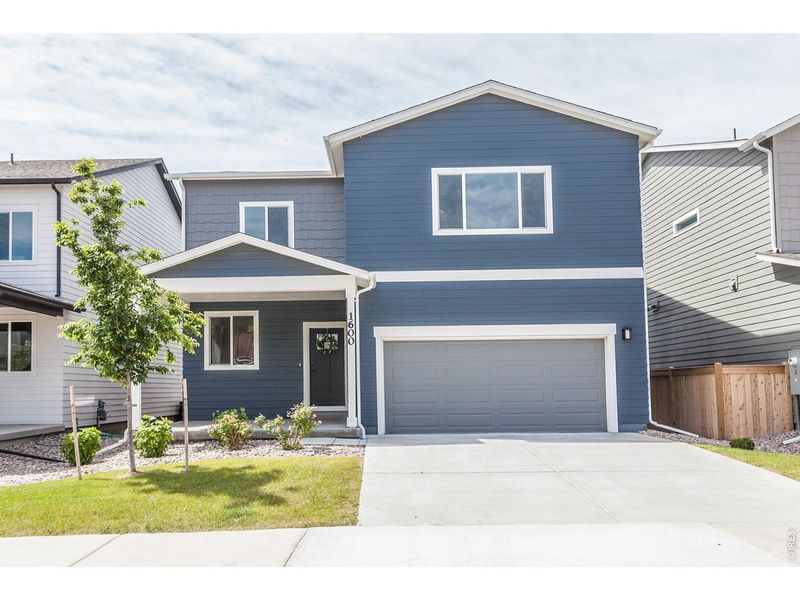 Front exterior of a new home in , Johnstown, CO, highlighting curb appeal (Image 1). Front exterior of a new home in , Johnstown, CO, highlighting curb appeal (Image 1).