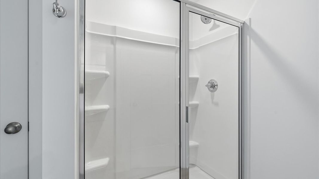 Exceptional en-suite with dual vanity and glass-enclosed walk-in shower for superior everyday comfort Exceptional en-suite with dual vanity and glass-enclosed walk-in shower for superior everyday comfort