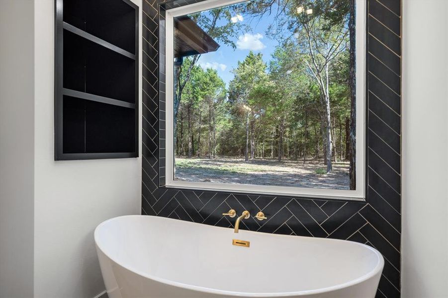 Full bathroom with a freestanding tub and plenty of natural light