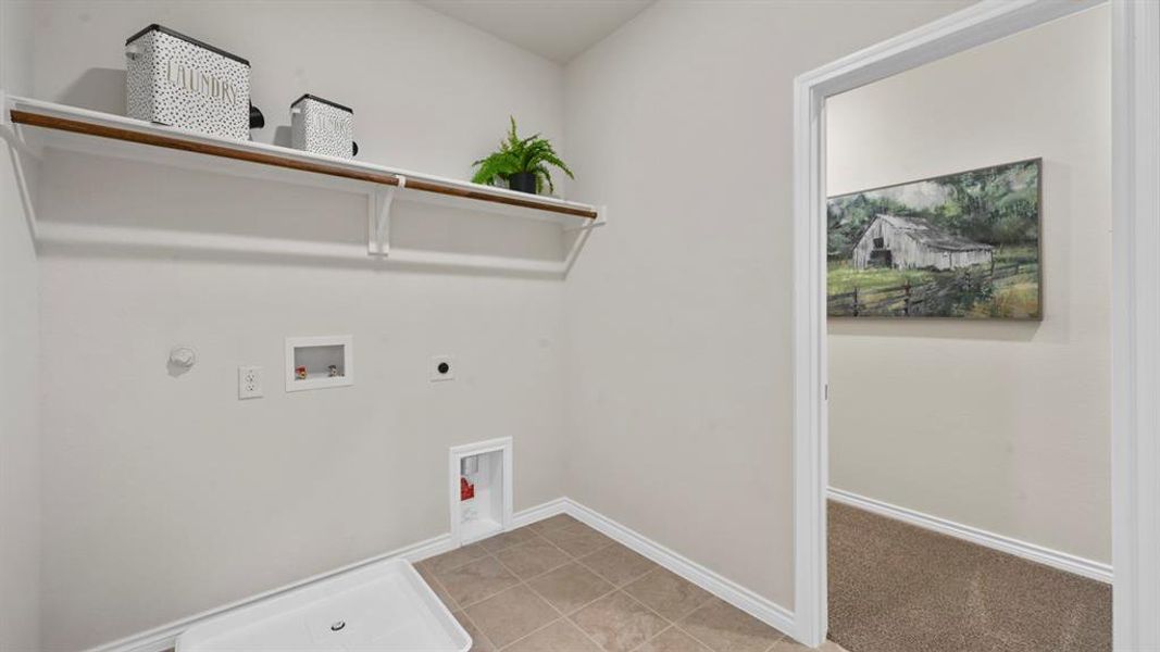 Laundry area featuring hookup for a washing machine, hookup for a gas dryer, hookup for an electric dryer, and light tile patterned flooring