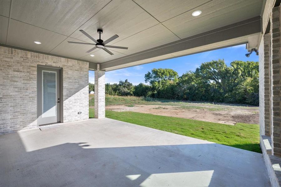 View of patio / terrace with ceiling fan, lighting and gorgeous 1.649 acre lot backing up to a greenbelt