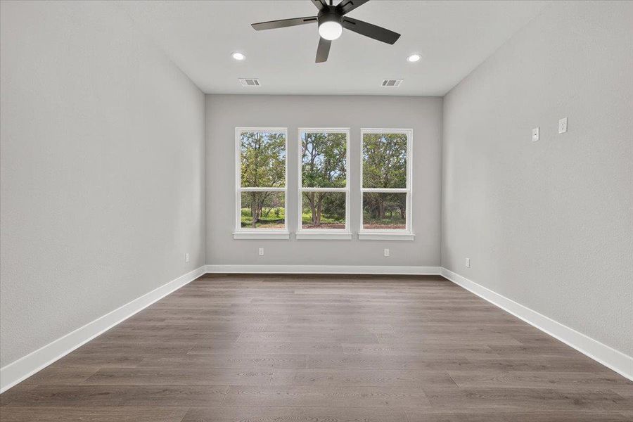 Natural light floods this spacious room, highlighting the contemporary flooring and outdoor scenery. Natural light floods this spacious room, highlighting the contemporary flooring and outdoor scenery.