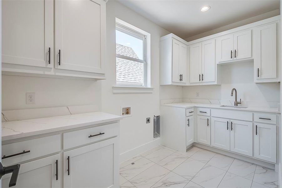 Laundry area featuring cabinets, washer hookup, electric dryer hookup, and sink