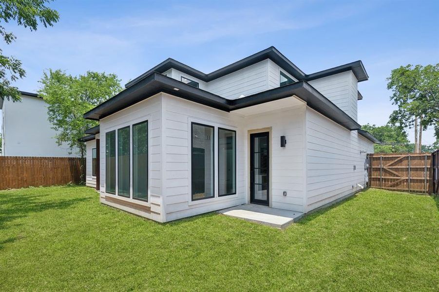 Rear view of house featuring a yard