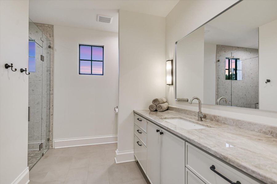Full bath featuring healthy amount of natural light, vanity, and a shower stall Full bath featuring healthy amount of natural light, vanity, and a shower stall