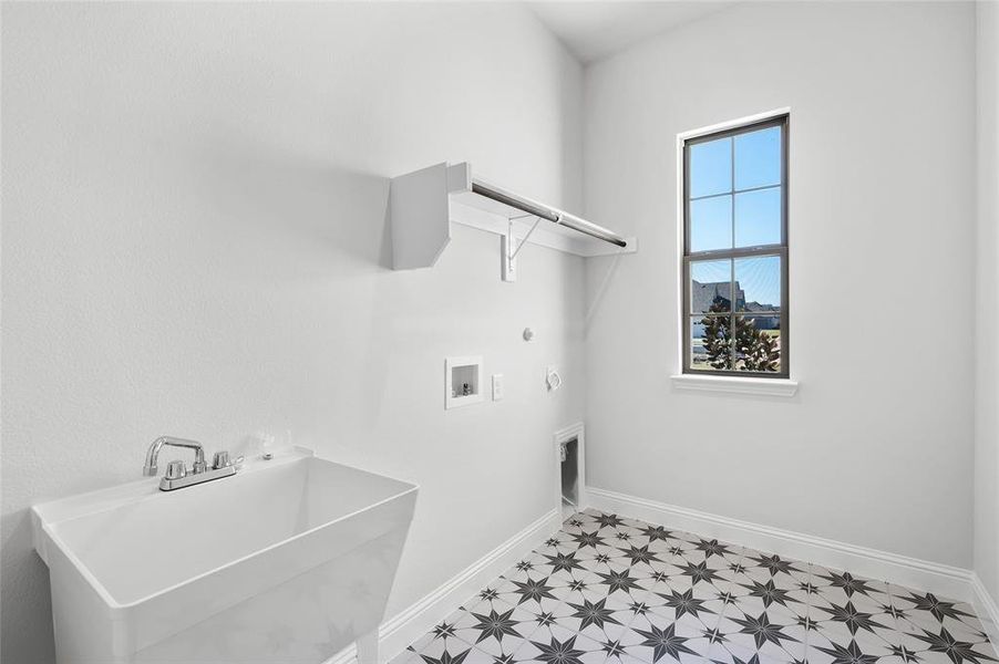 Laundry room with hookup for a gas dryer, hookup for a washing machine, hookup for an electric dryer, and light flooring Laundry room with hookup for a gas dryer, hookup for a washing machine, hookup for an electric dryer, and light flooring