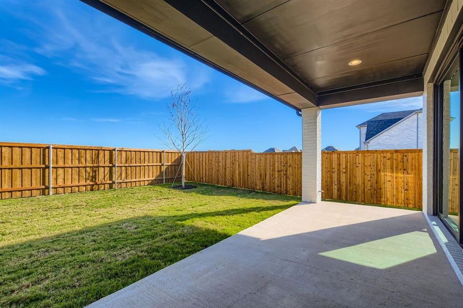 Fenced backyard featuring a patio area Fenced backyard featuring a patio area