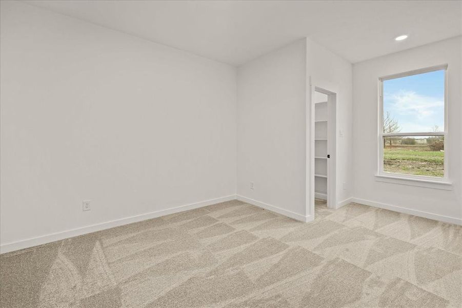 Empty room featuring light colored carpet