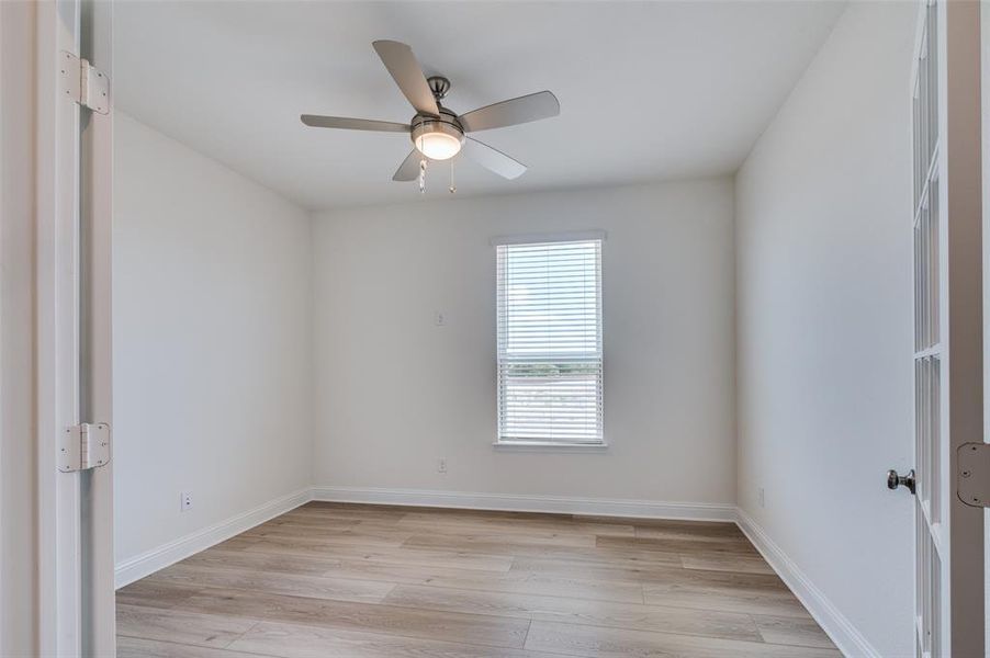 Spare room featuring light wood-style floors and a ceiling fan