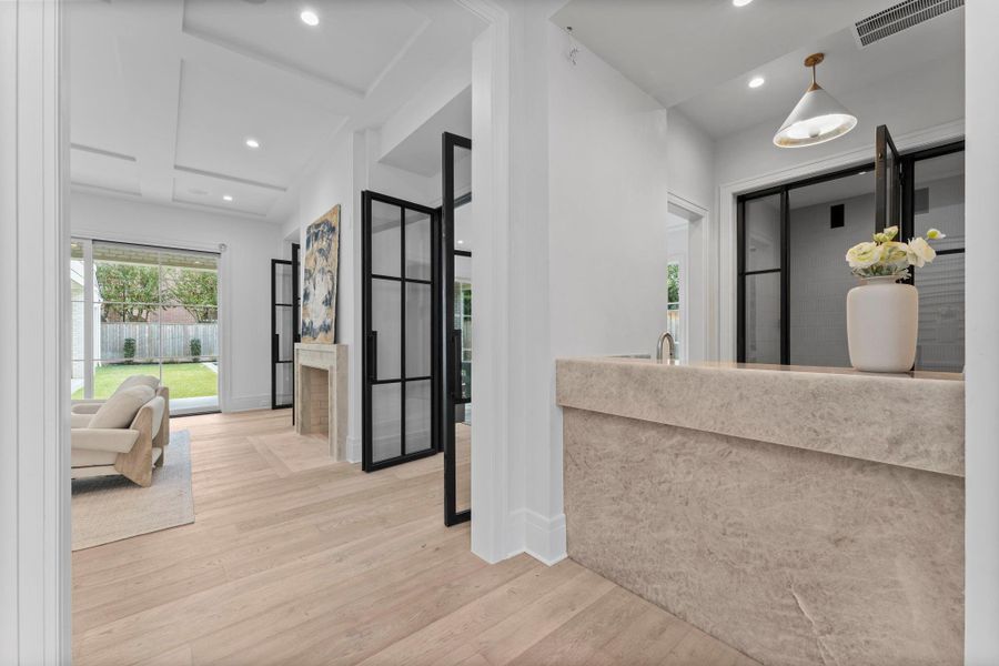 The wet bar sits adjacent to the formal study, fully equipped with gold hardware and temperature controlled wine room The wet bar sits adjacent to the formal study, fully equipped with gold hardware and temperature controlled wine room