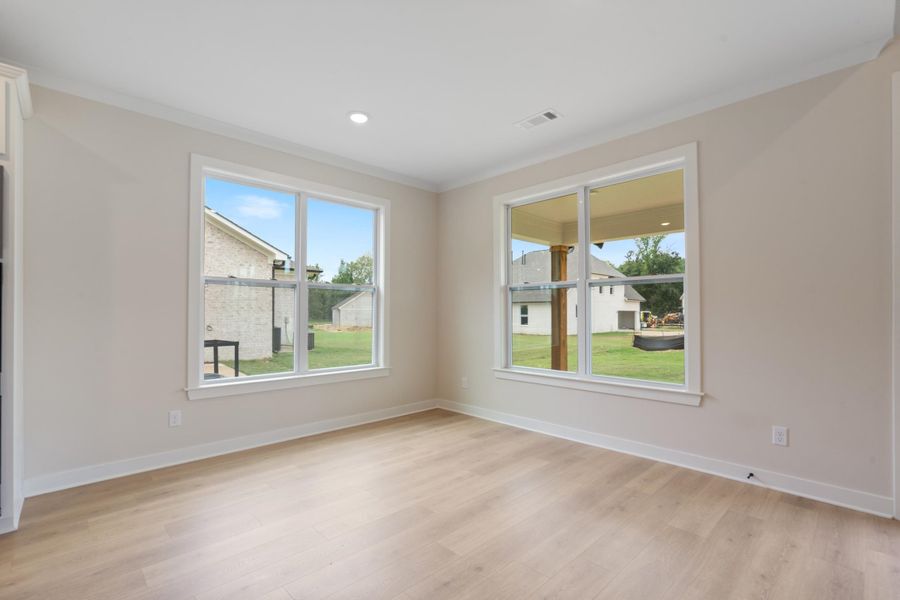 Recessed ceiling lighting, crown molding, wood-finish flooring, and multiple windows Recessed ceiling lighting, crown molding, wood-finish flooring, and multiple windows