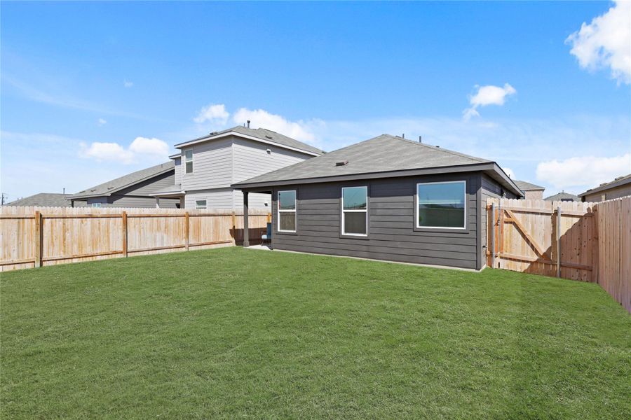 Back of property with a fenced backyard