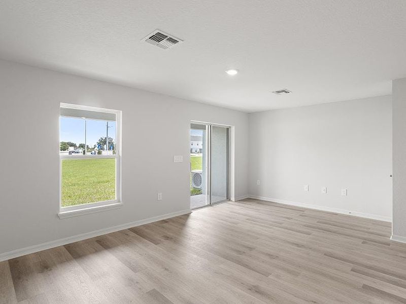 This 2-story townhome features a bright, open living area - Aruba townhome by Highland Homes