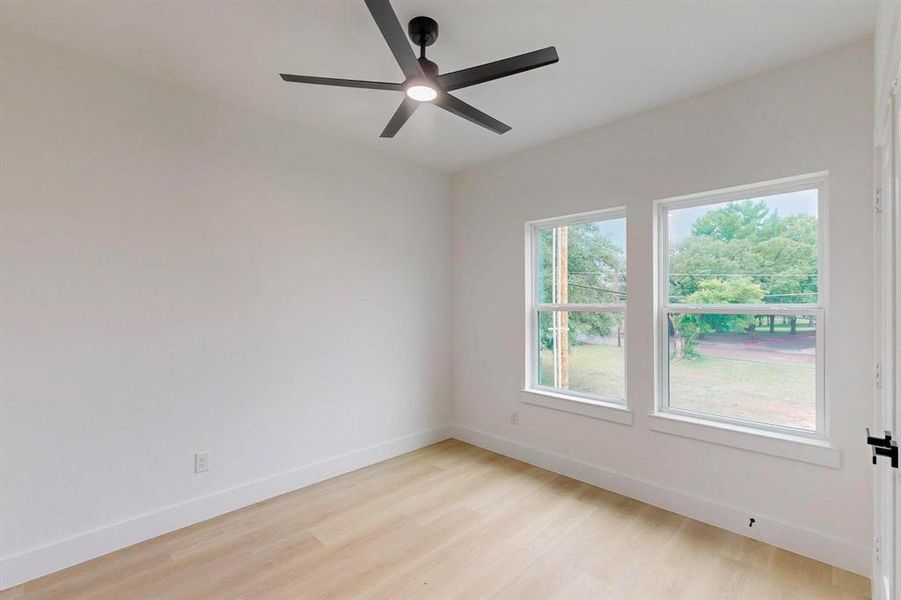 Spare room featuring light wood finished floors and ceiling fan Spare room featuring light wood finished floors and ceiling fan
