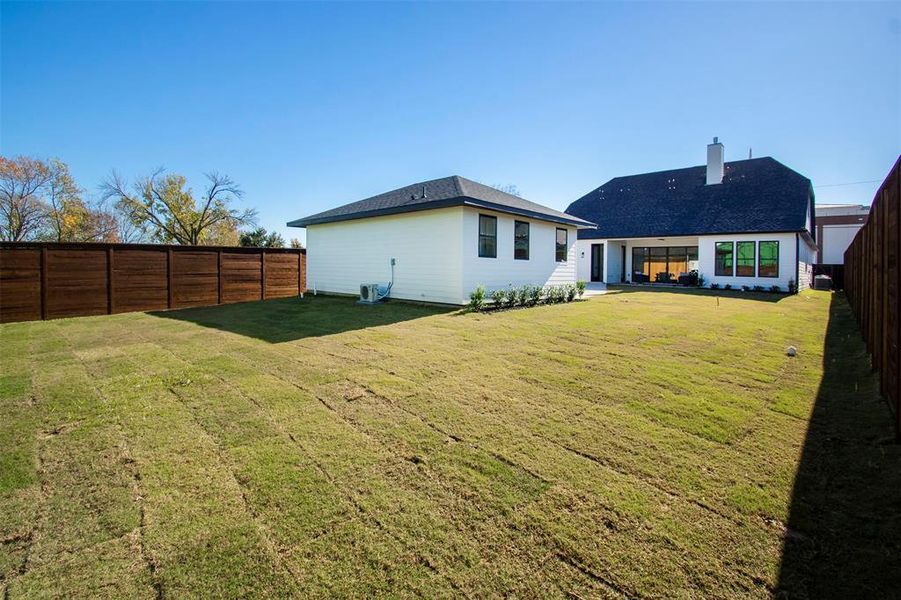 Rear view of property featuring a yard