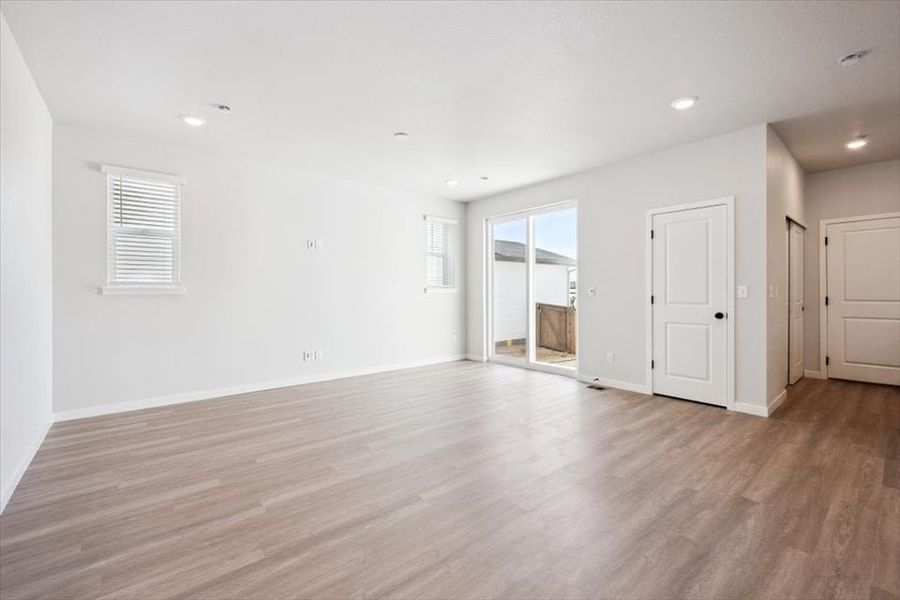 A room with white walls and wood floors.