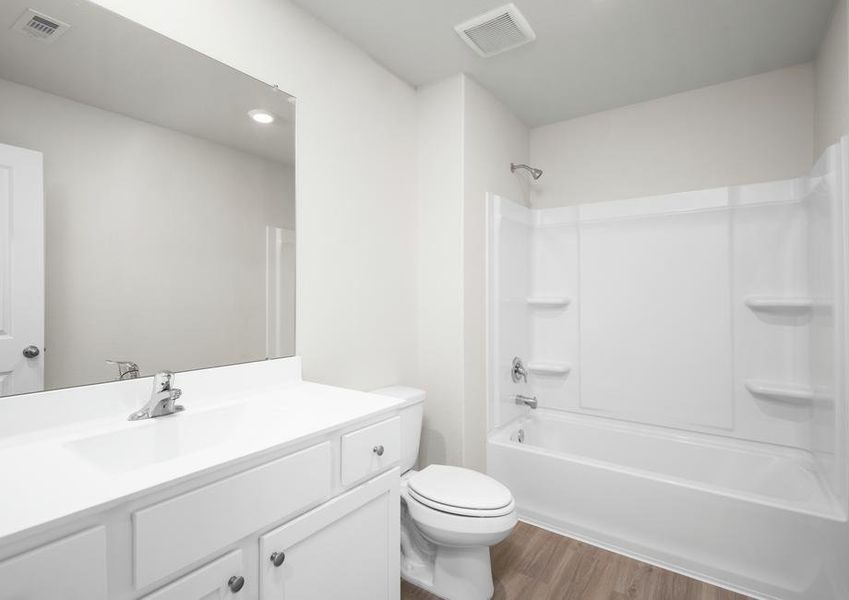 The secondary bathroom is filled with storage space.