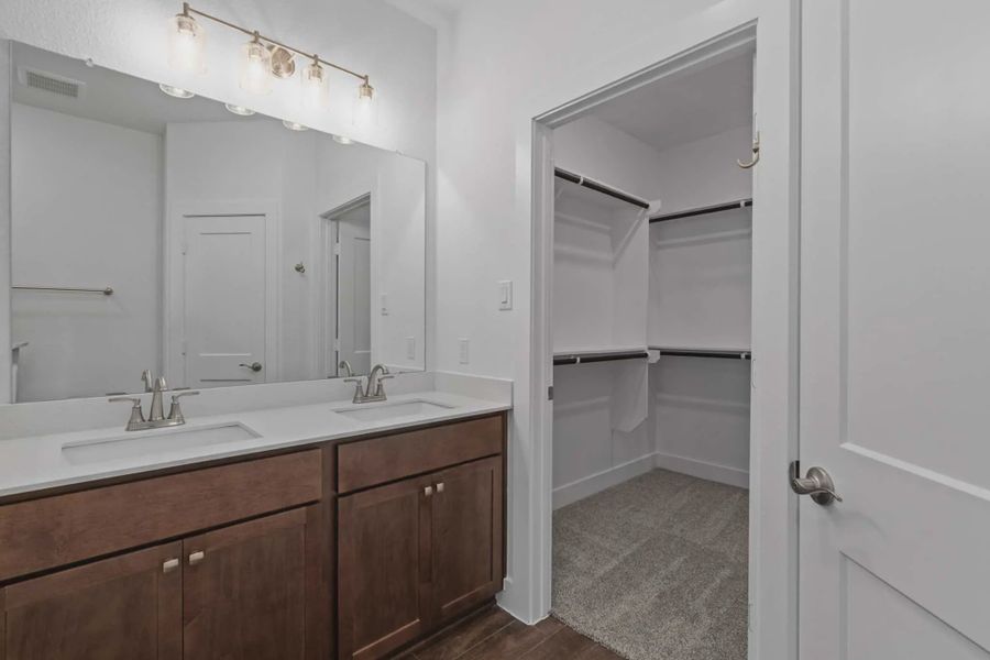Representative furnished interior of a home built from the Carriagehouse by Chesmar Homes in Meridiana Townhomes, Iowa Colony (Image 19).