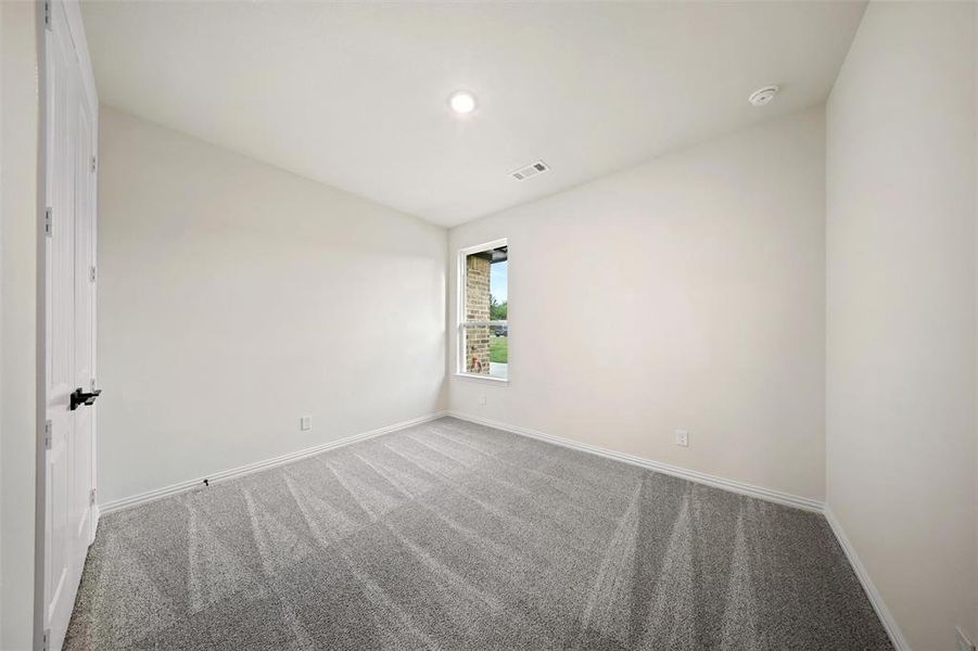 Carpeted empty room with baseboards and recessed lighting