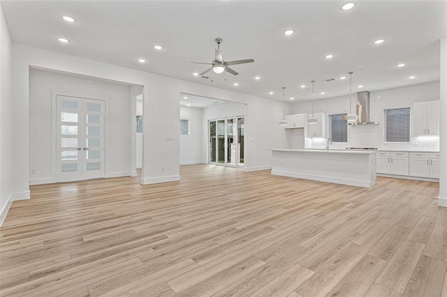 Unfurnished living room featuring recessed lighting, ceiling fan, and light wood-type flooring
