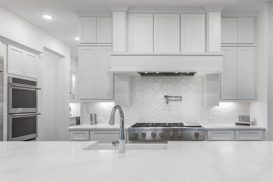 Upgraded tile backsplash and pot filler complete the look and needs! All of the drawers and cabinets in the house are soft-close.