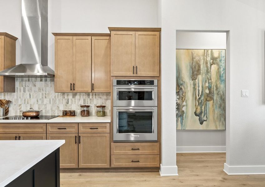 The kitchen has a stacked microwave and oven wall.