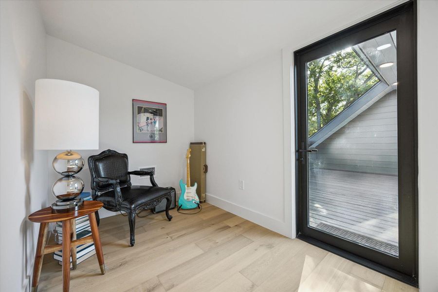 Sitting room with light wood finished floors and baseboards Sitting room with light wood finished floors and baseboards