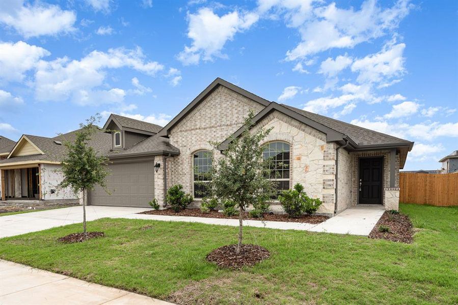 View of front facade with a garage and a front lawn