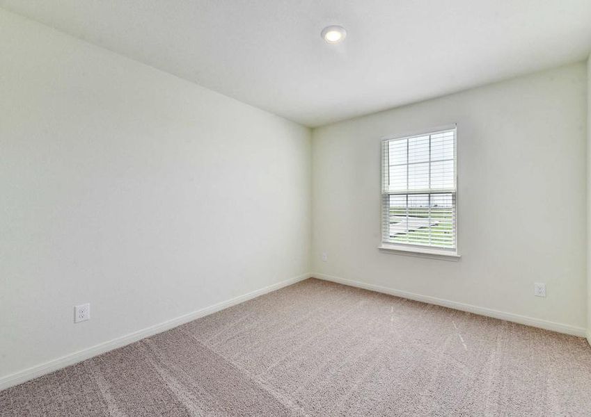 Rio bedroom with overhead light, white trim to walls, and soft brown carpet