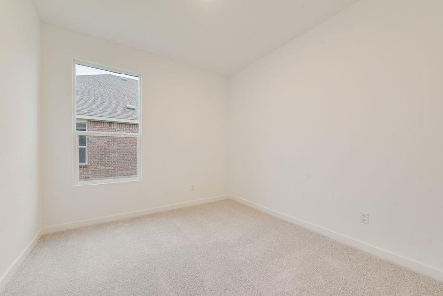 Spare room with light colored carpet and baseboards Spare room with light colored carpet and baseboards