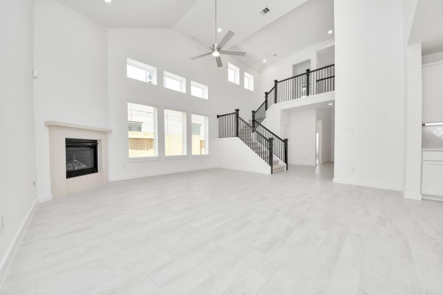 Welcome family and guests to your charming living room! With its high ceilings, recessed lighting, ceiling fan, custom paint, beautiful flooring, and large windows that let in abundant natural light, this room is perfect for gatherings. Welcome family and guests to your charming living room! With its high ceilings, recessed lighting, ceiling fan, custom paint, beautiful flooring, and large windows that let in abundant natural light, this room is perfect for gatherings.