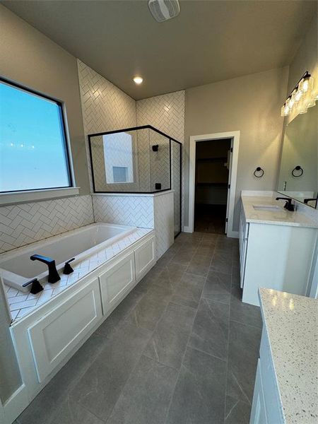 Bathroom featuring independent shower and bath, vanity, and tile patterned flooring