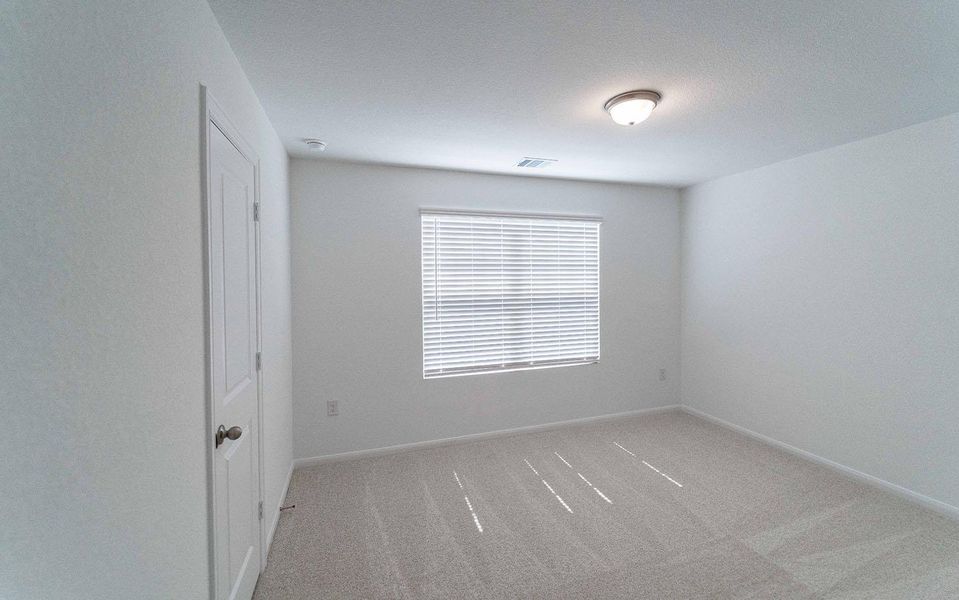 Unfurnished room featuring light carpet and baseboards Unfurnished room featuring light carpet and baseboards